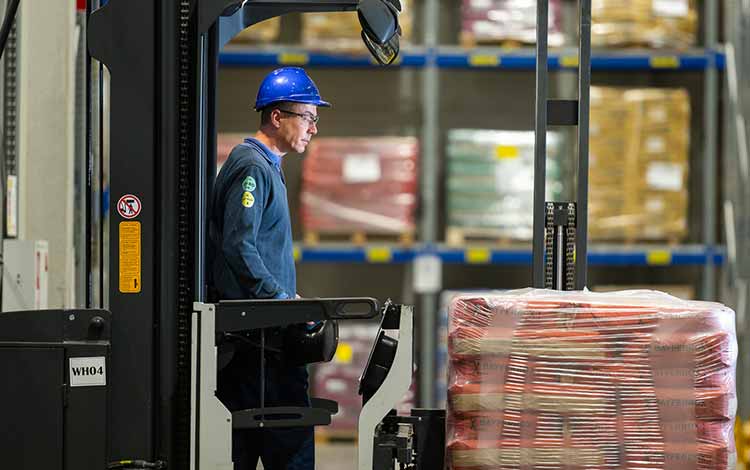 Man on forklift truck in safety gear