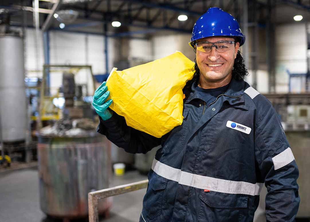 Smiling man carrying yellow package